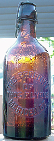 THOMAS F. LYONS WEISS BEER EMBOSSED BEER BOTTLE