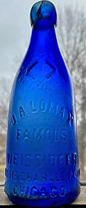 JOHN A. LOMAX FAMOUS WEISS BEER EMBOSSED BEER BOTTLE
